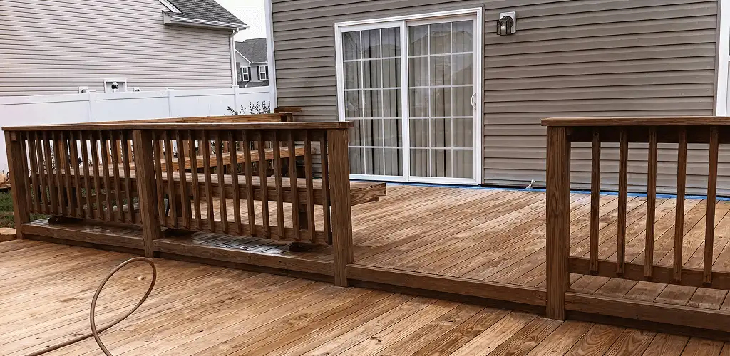 Deck sealing service protecting a backyard wood deck and railings in Columbus, GA