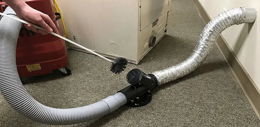 Dryer vent cleaning service removing lint from a dryer duct connection in Columbus, GA