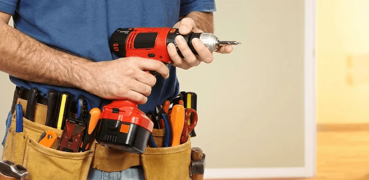 Handyman holding a power drill for home repairs and installations in Columbus, GA