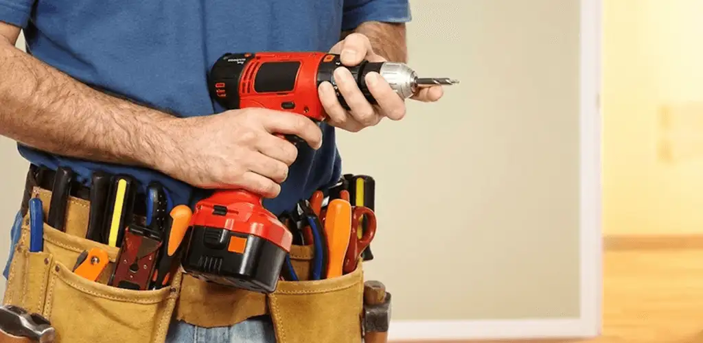 Handyman holding a power drill for home repairs and installations in Columbus, GA