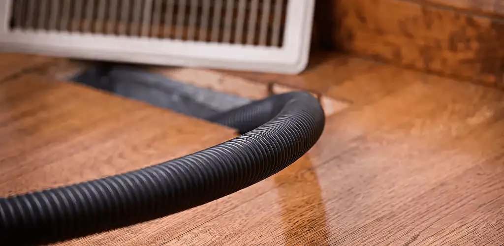 Air duct cleaning hose inserted into a floor vent for ductwork cleaning in Columbus, GA